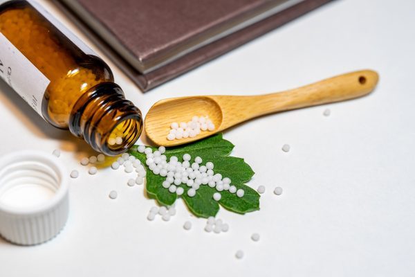 Homeopathic medicine on leaf.